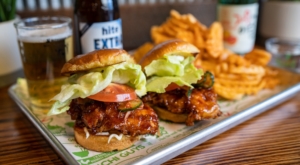 kimchi guys fried chicken sliders with chips and a beverage